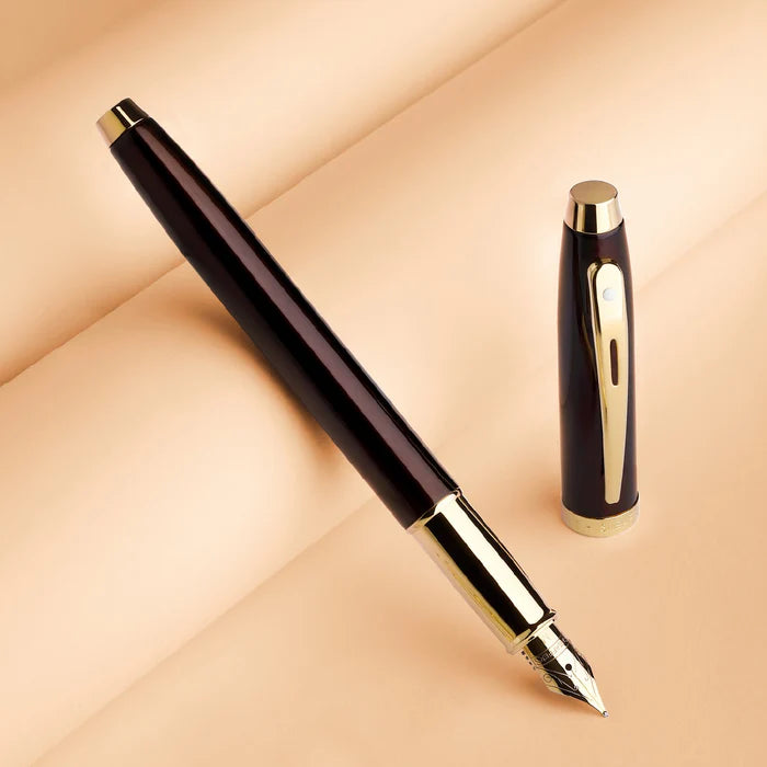 Sheaffer 100 9370 Glossy Coffee Brown Fountain Pen With PVD Gold-Tone Trims on a beige background