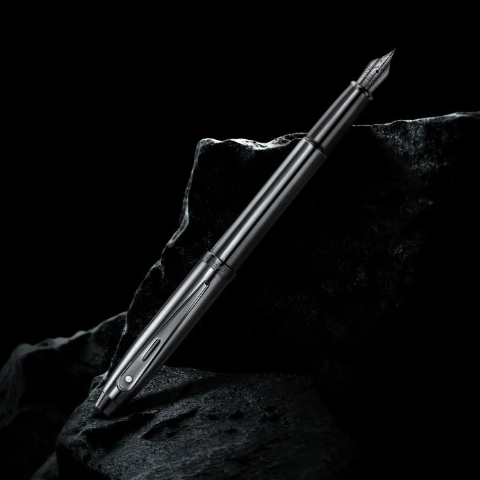 Sheaffer 100 9375 Ionic Gunmetal Grey Fountain Pen with PVD Trims on dark stone surface