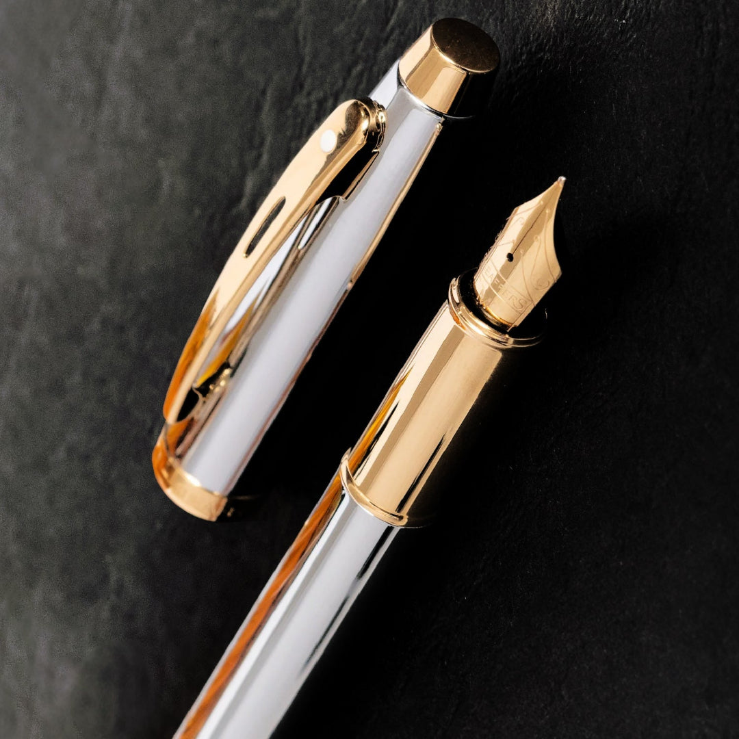 Sheaffer 100 Chrome Fountain Pen With Gold Trims on a dark surface