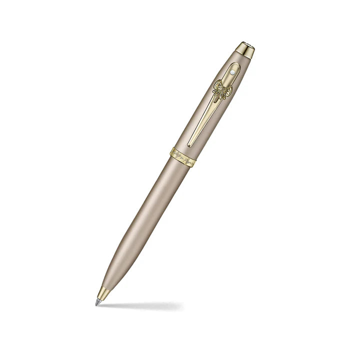 Sheaffer 100 Emily in Paris 9377 Champagne Gold Ballpoint Pen with Champagne Gold Trims and Bow-Shaped Clip Emblem angled writing shot