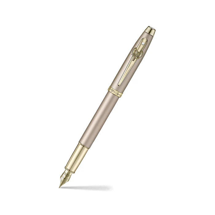 Sheaffer 100 Emily in Paris 9377 Champagne Gold Fountain Pen with Champagne Gold Trims and Bow-Shaped Clip Emblem angled writing shot