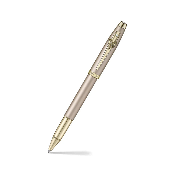 Sheaffer 100 Emily in Paris 9377 Champagne Gold Rollerball Pen with Champagne Gold Trims and Bow-Shaped Clip Emblem angled writing shot
