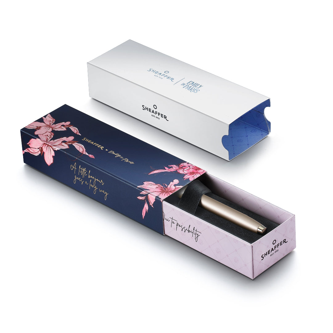 Sheaffer 100 Emily in Paris 9377 Champagne Gold Rollerball Pen with Champagne Gold Trims and Bow-Shaped Clip Emblem in packaging