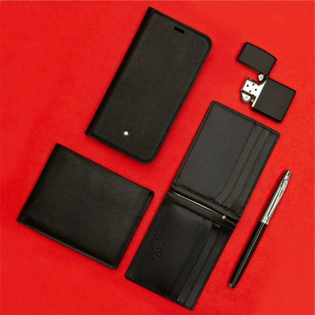 Sheaffer 100 Glossy Black Barrel Rollerball Pen With Brushed Chrome Cap beside black leather accessories