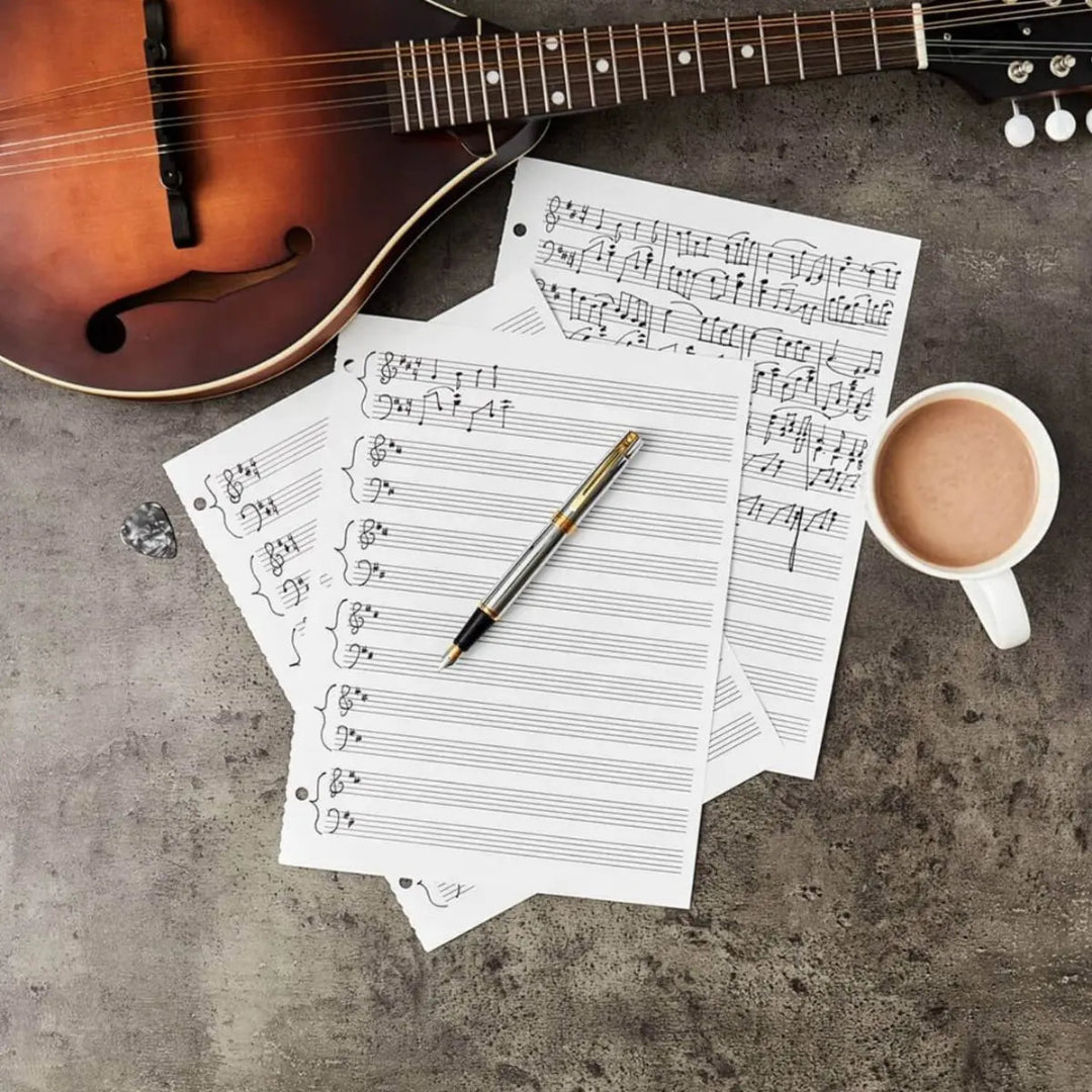 Guitar, music sheet, coffee and Sheaffer 300 Bright Chrome Fountain Pen With Gold Trims on a concrete surface