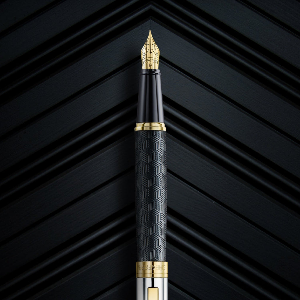 Close up of Sheaffer 300 Engraved Matte Black Fountain Pen With Chrome and Gold Trims on black backrgound