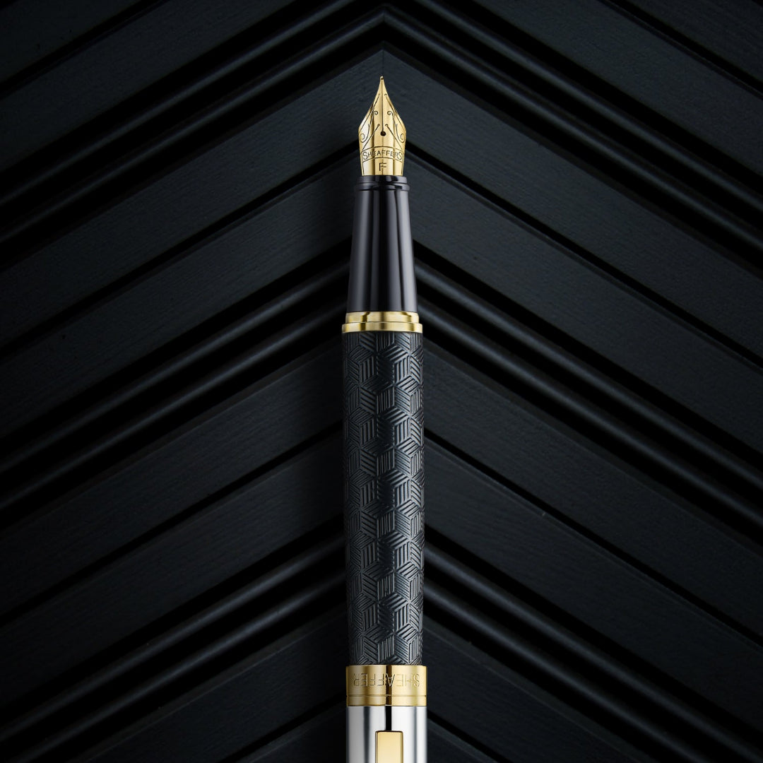 Close up of Sheaffer 300 Engraved Matte Black Fountain Pen With Chrome and Gold Trims on black backrgound