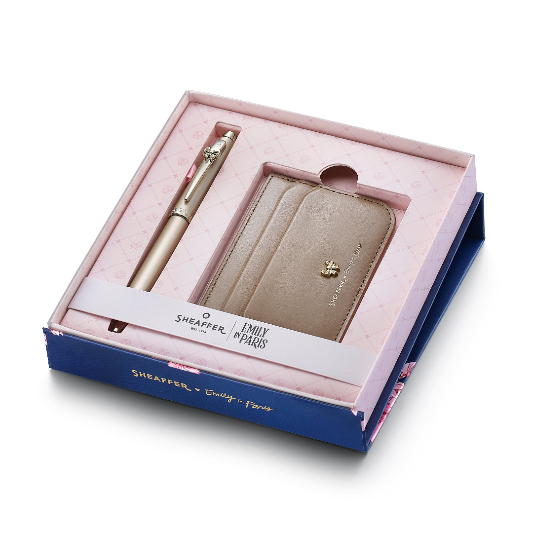Sheaffer Gift Set ft. 100 Emily in Paris 9377 Champagne Gold Ballpoint Pen with Champagne Gold Trims and Full-Grain Credit Card Holder inside packaging