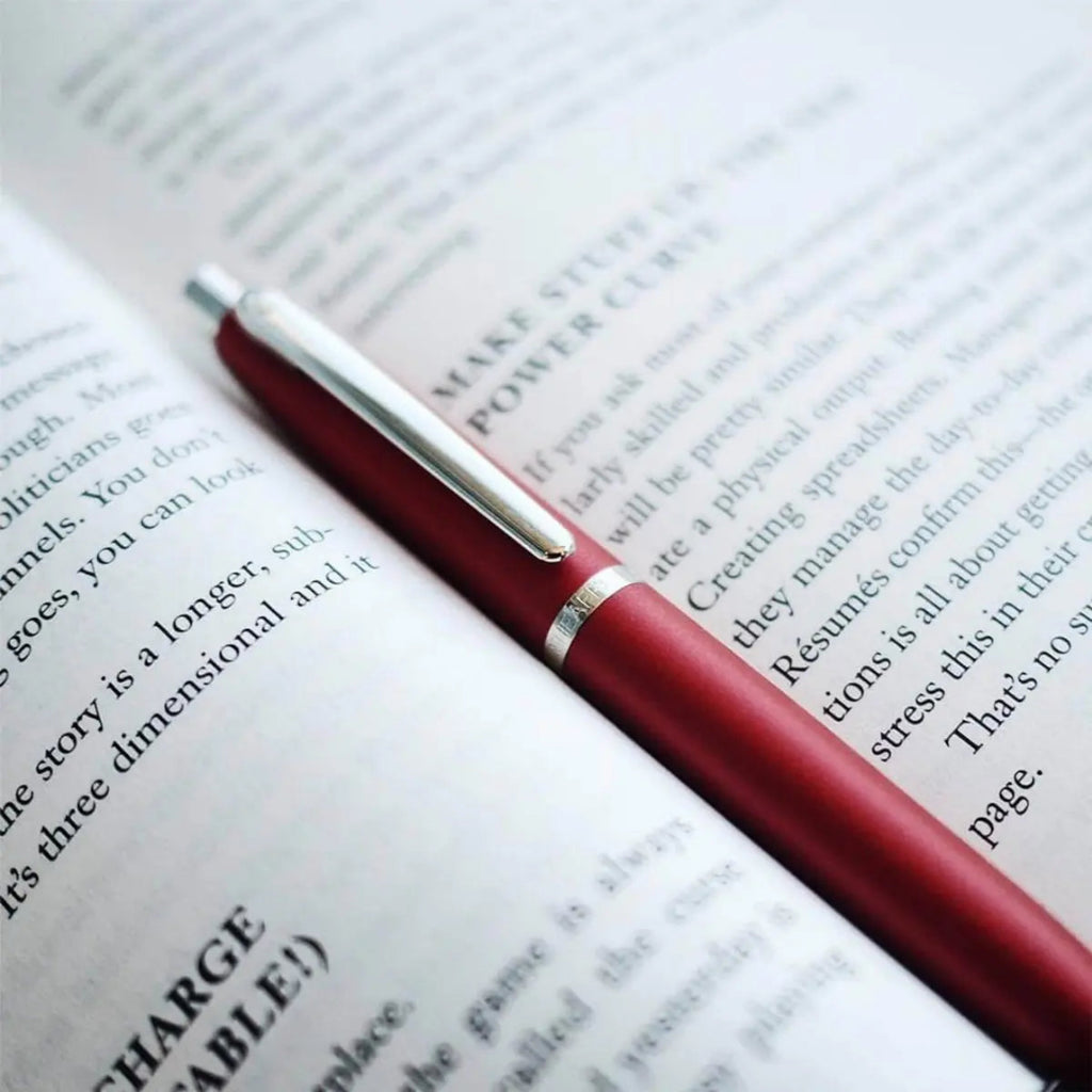 Sheaffer VFM Excessive Red Ballpoint Pen on top of an open book